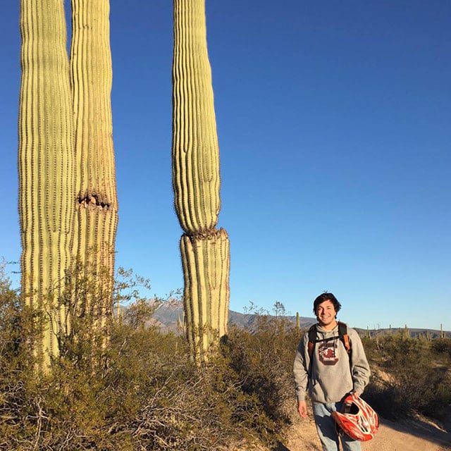 Chandler out west chilling with a cactus